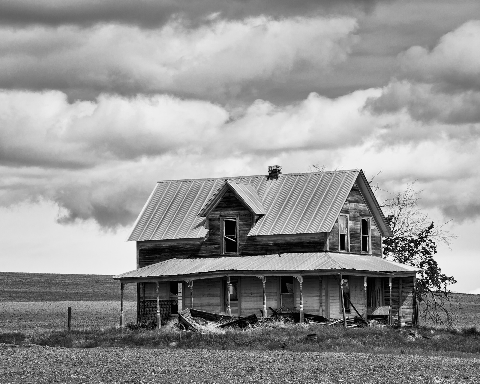 A black and white photograph of an old abandoned farmhouse in rural Douglas County, Washington.