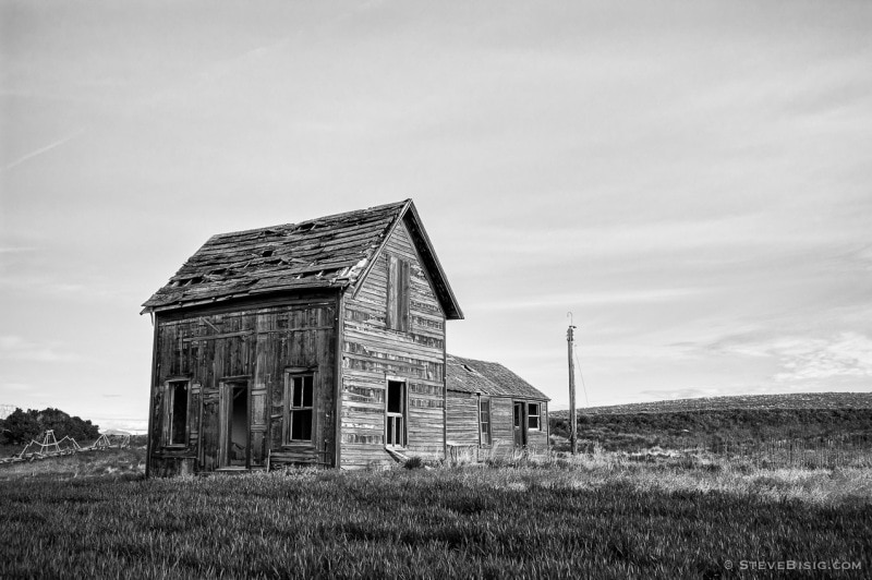 A black and white photograph of old abandoned house on 8-1/2 Road NW in rural Douglas County, Washington.