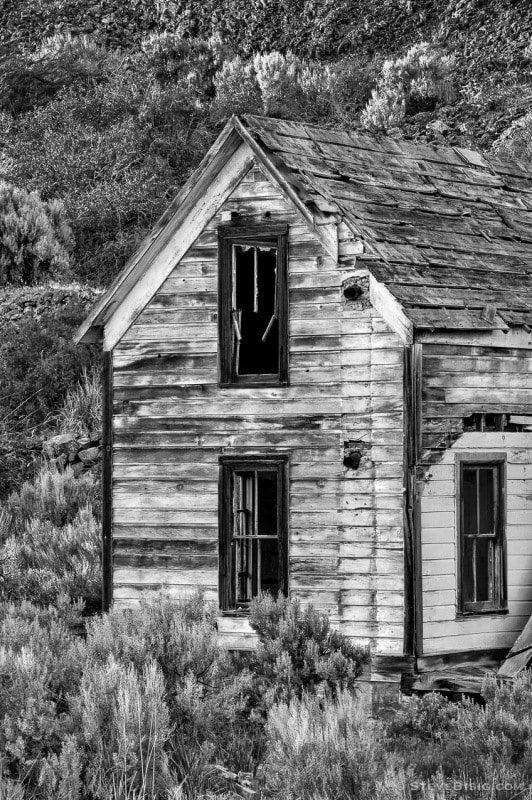 A black and white photograph of an old abandoned farm house in Alstown, Washington.