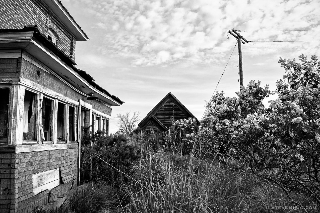 A black and white photograph of old abandoned house on D Road NW in rural Douglas County, Washington.