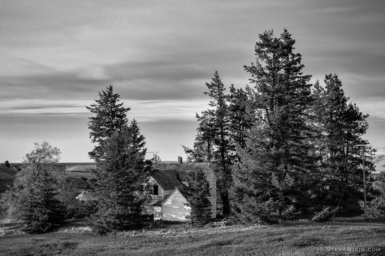 A black and white photograph of old abandoned farm house in rural Douglas County, Washington.