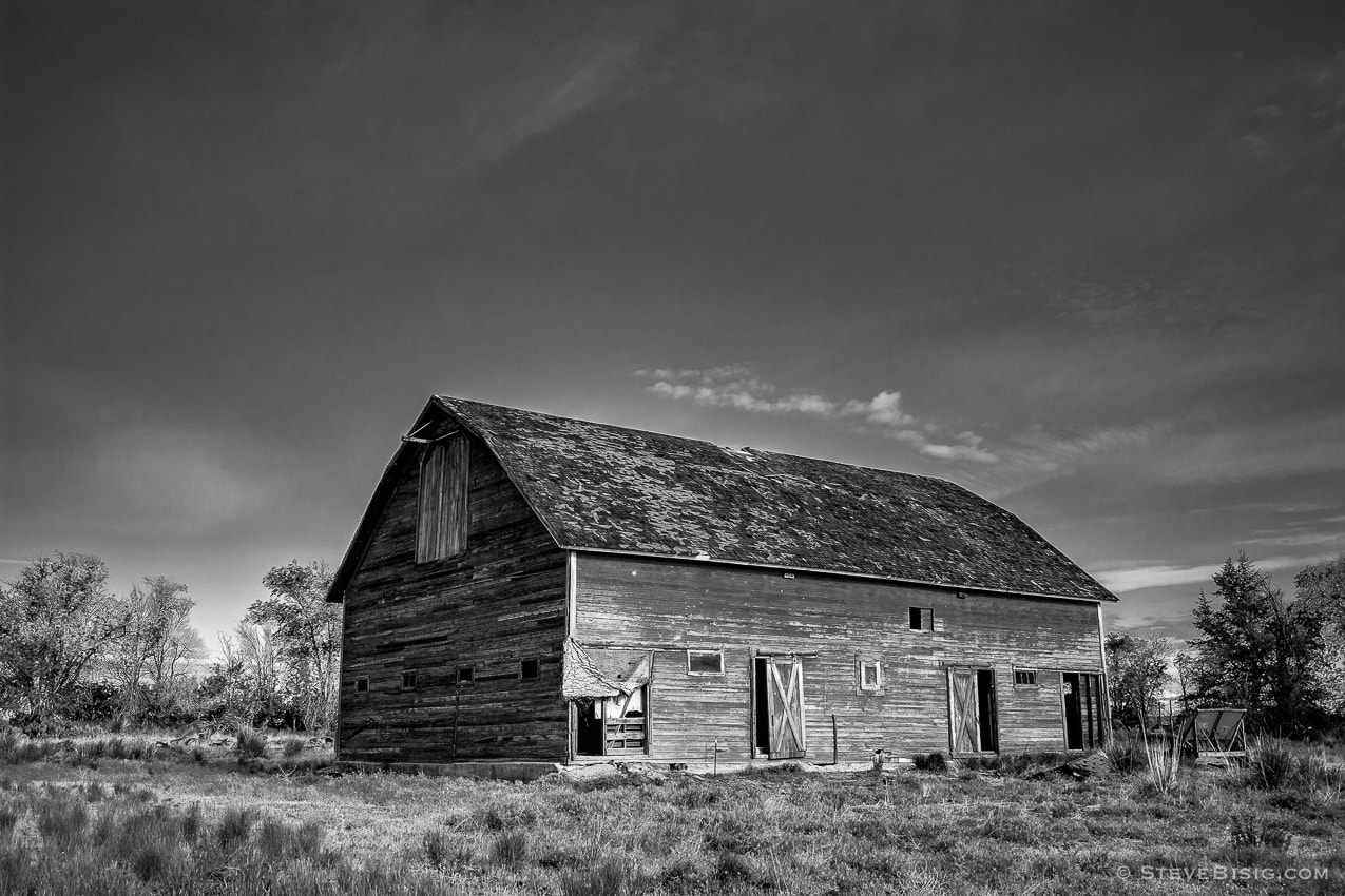 A black and white photograph of an old barn in rural Douglas County, Washington.