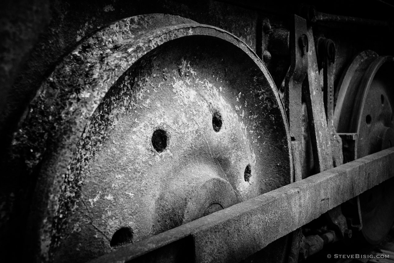 A black and white photograph of old rusty coal mining equipment in Roslyn, Washington.