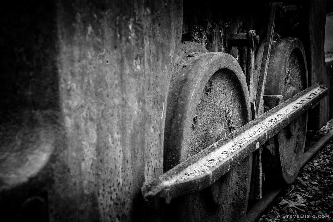 A black and white photograph of old rusty coal mining equipment in Black Diamond, Washington.