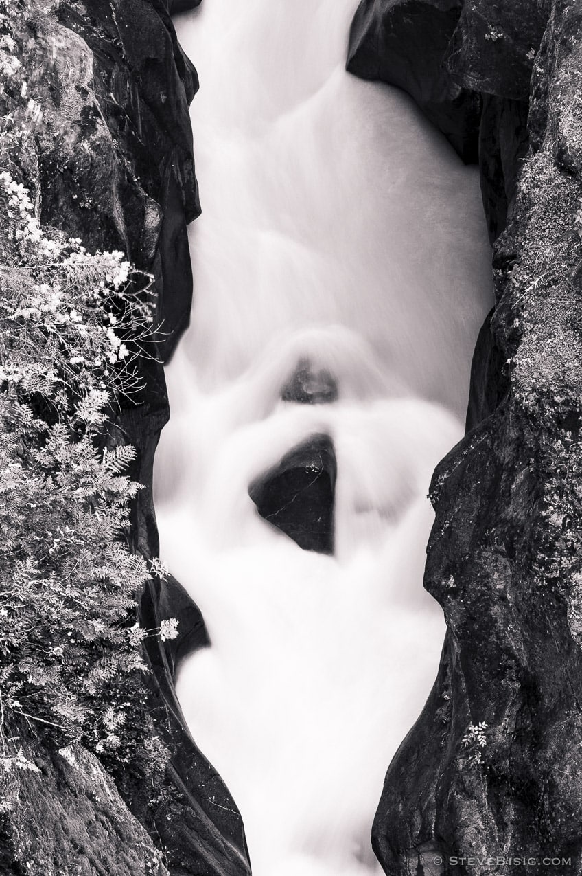 A black and white photograph of the Muddy Fork of the Cowlitz River as it passes through Box Canyon at Mount Rainier National Park, Washington.