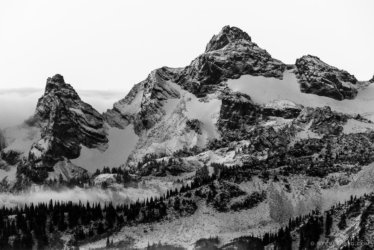 A black and white photograph of a view of an autumn sunrise shining on the Tatoosh Range in Mount Rainier National Park, Washington.
