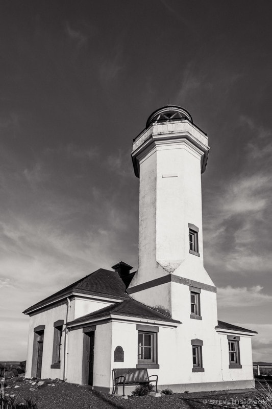A black and white photograph of the Point Wilson Lighthouse located at the Fort Worden State Park near Port Townsend, Washington.