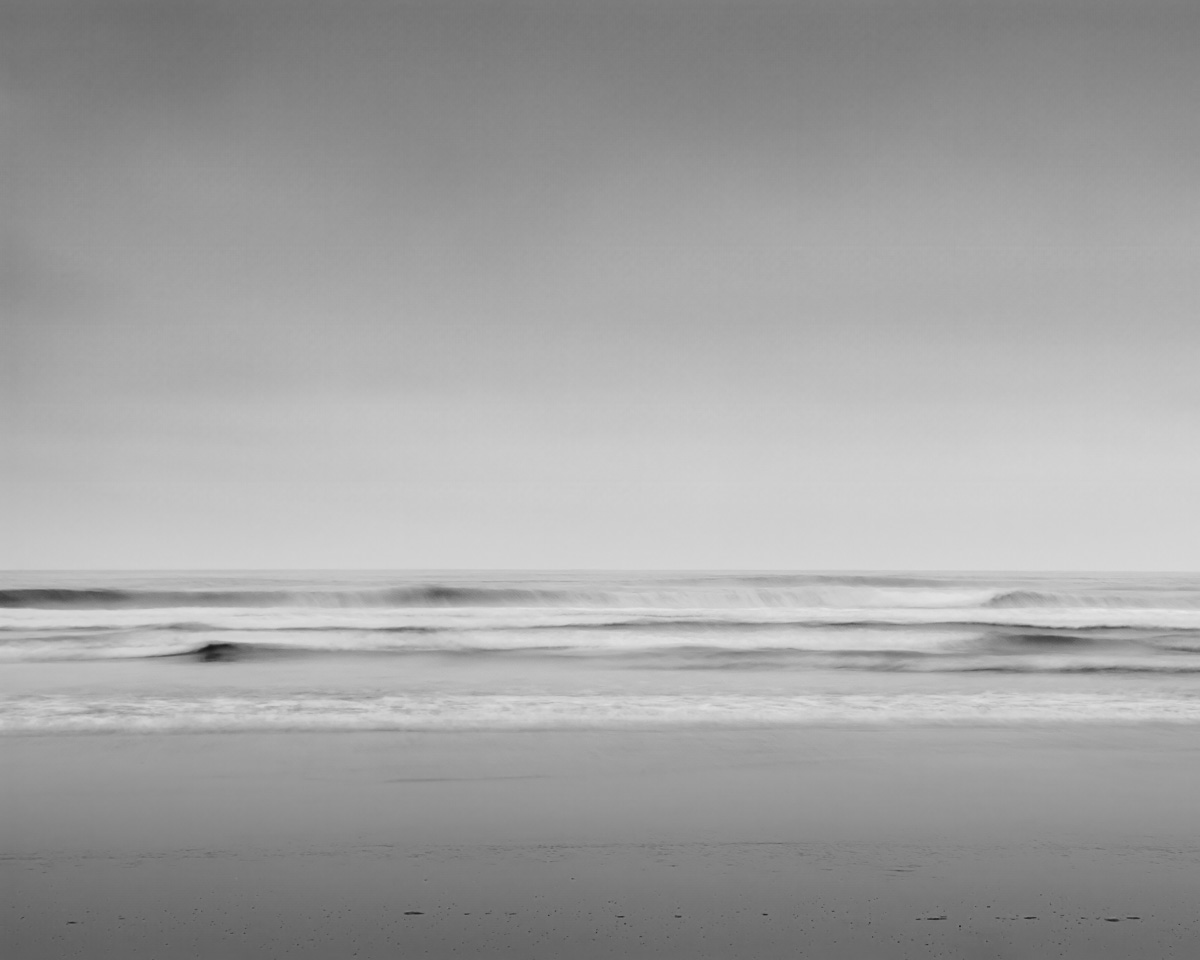 This mesmerizing black and white photograph captures the serene beauty of Kalaloch Beach along the Olympic Peninsula, Washington. The long exposure technique imbues the Pacific Ocean waves with a mystical, ethereal quality, blurring motion and time. The minimalist landscape, where the sea meets the sky, invites viewers into a world of peaceful reflection and timeless beauty.