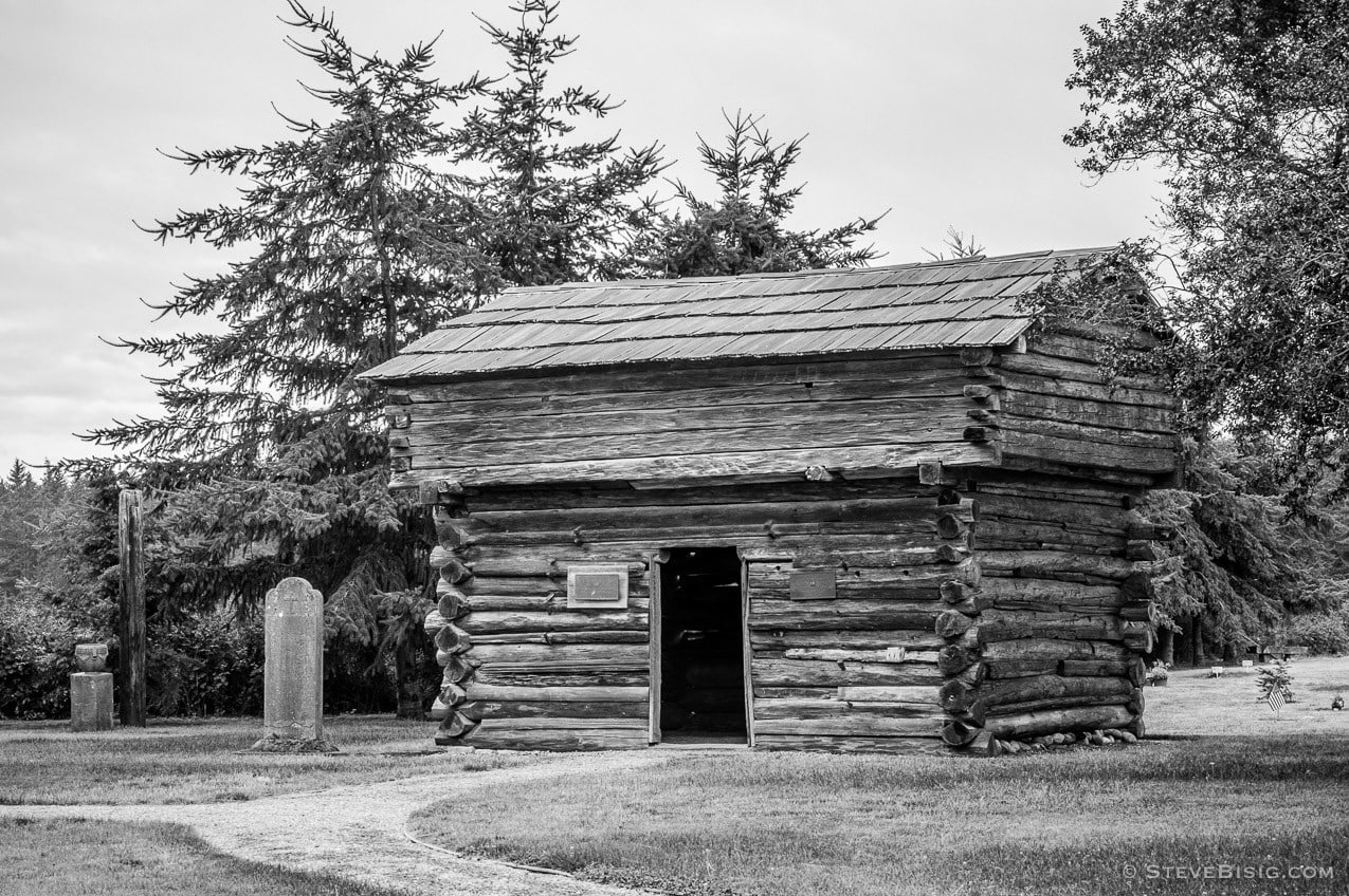 A black and white fine art photograph of the Davis Blockhouse on Whidbey island near Coupeville, Washington.