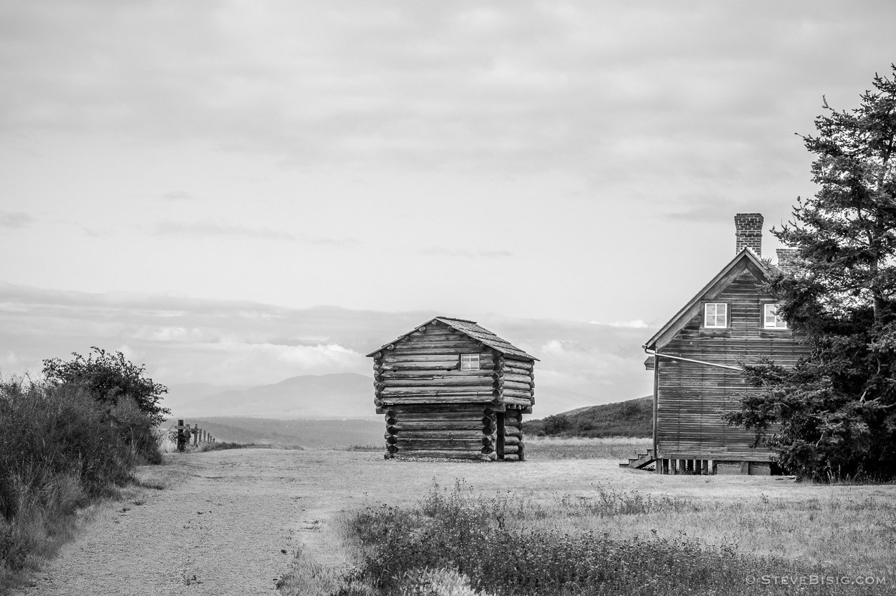 A black and white fine art photograph of the Jacob Ebey's home and blockhouse on Whidbey Island near Coupeville, Washington.