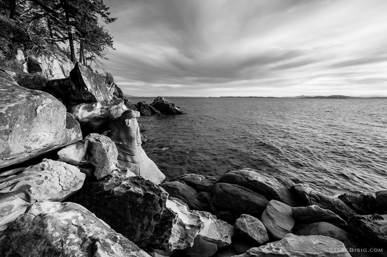 A black and white fine art photograph of the rocky coastline on Samish Bay at Larrabee State Park in Whatcom County near Bellingham, Washington.