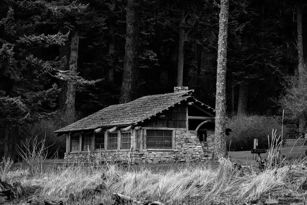 A black and white photograph of the Civilian Conservation Corps (CCC) picnic shelter on Bowman Bay at Deception Pass State Park, Fidalgo Island, Washington.