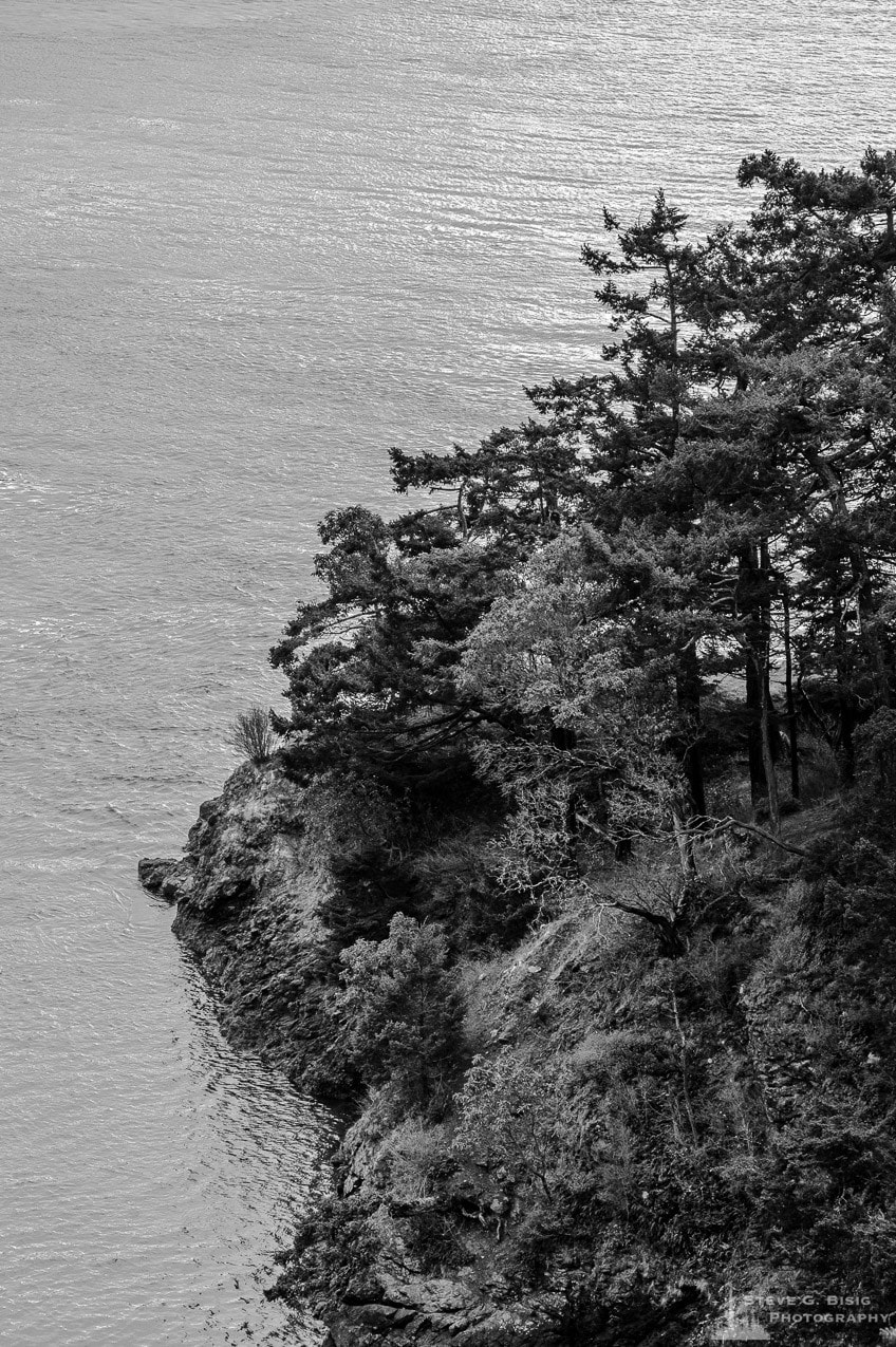 A black and white landscape photograph of the rocky coastline at Deception Pass State Park, Fidalgo Island, Washington.