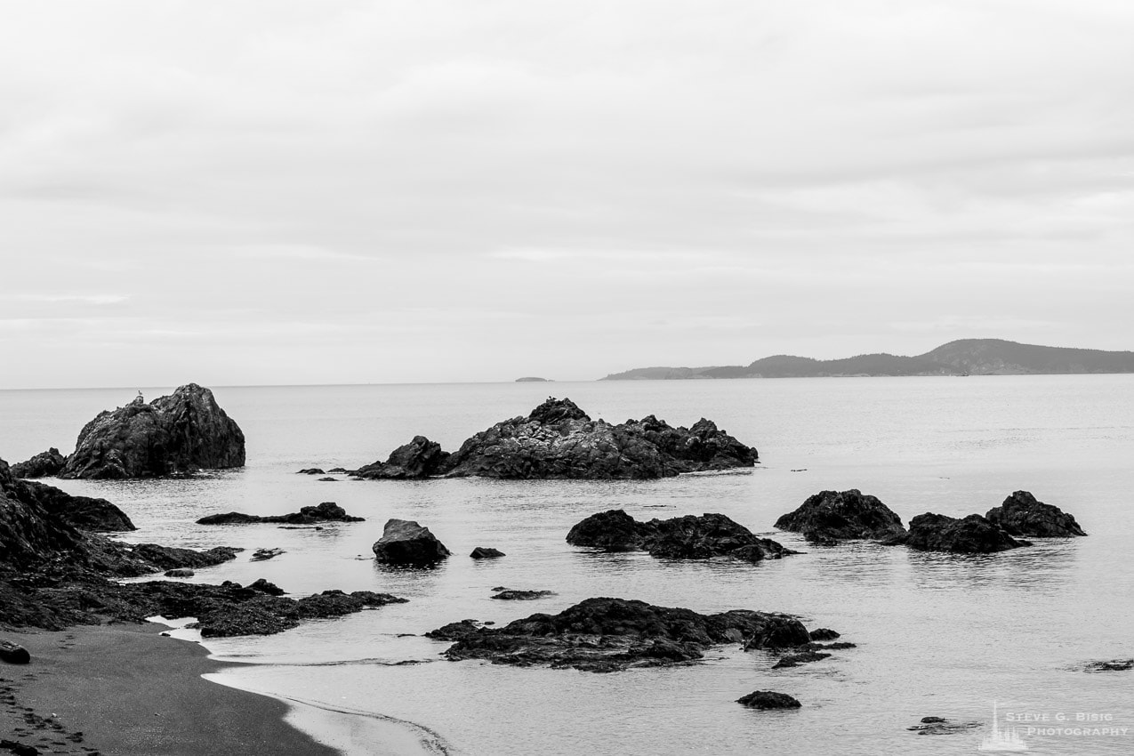 A black and white landscape photograph of the rocks (Urchin Rocks) along Rosario Beach at Deception Pass State Park on Fidalgo Island, Washington.