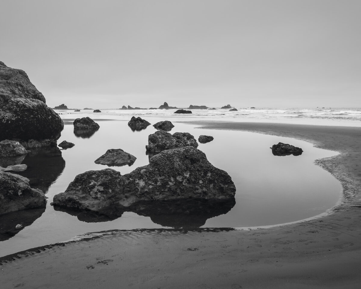A black and white landscape photograph of the rocky tidal pools at Ruby Beach in the Olympic National Park along the coast of Washington State.
