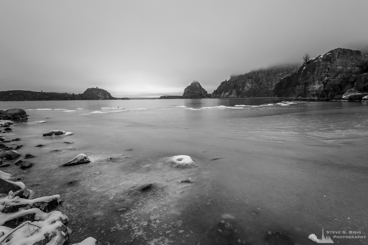 A black and white photograph of a frozen Banks Lake as seen from Steamboat Rock State, Washington.