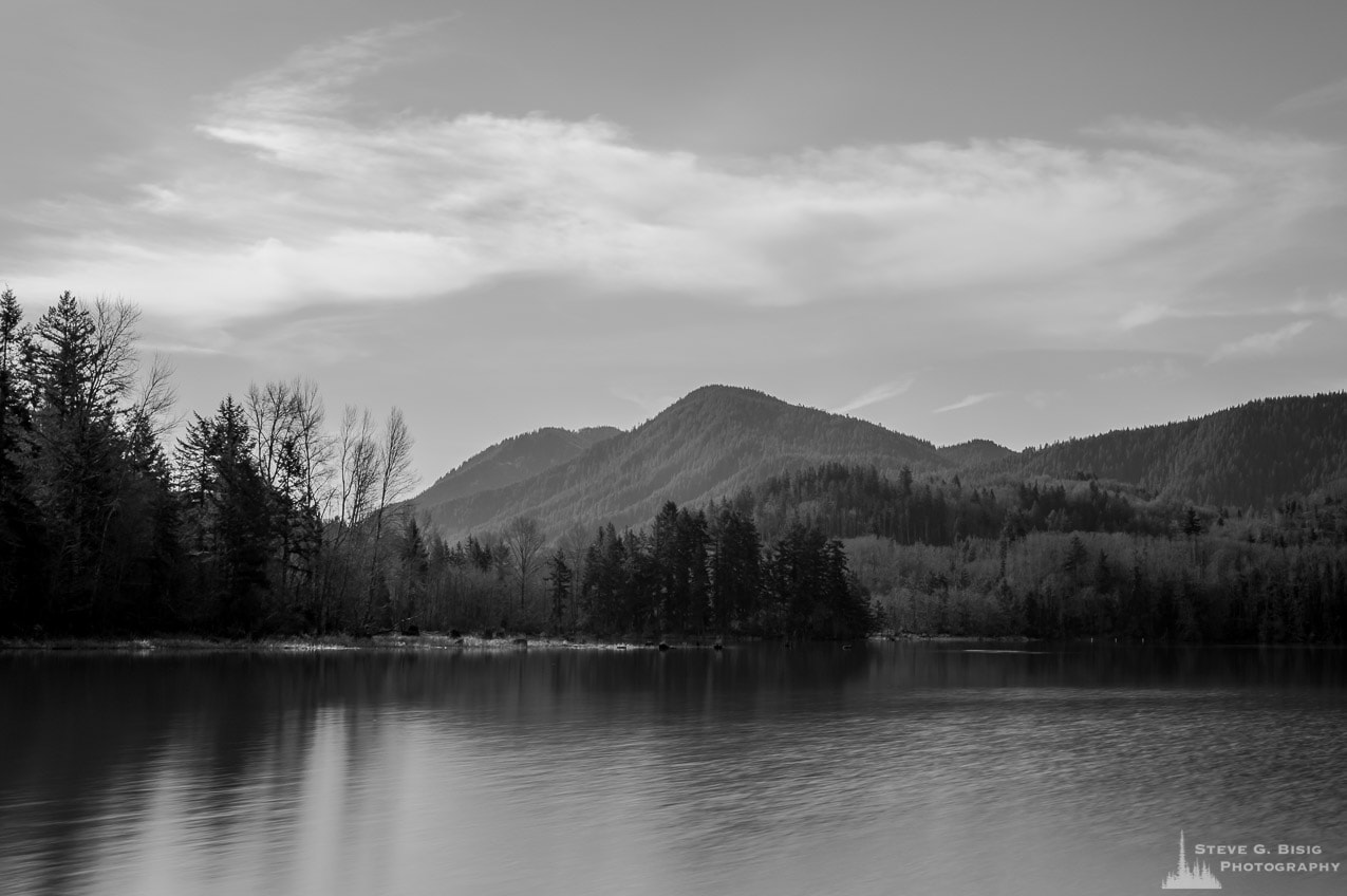 A black and white, long exposure photograph of Alder Lake in rural Pierce County, Washington on a sunny late Winter day.
