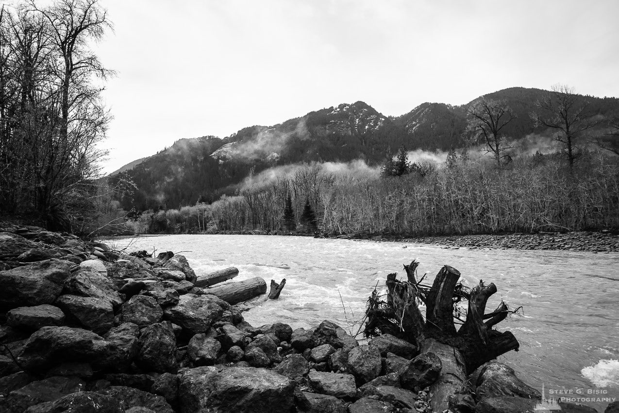 A black and white landscape photograph of the Winter flow of the Elwha River in the Olympic National Park, Washington.