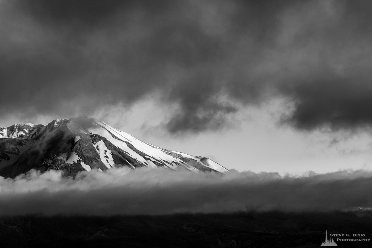 A black and white photograph of Mount Saint Helens shrouded by Summer clouds. Viewed from the Johnston Ridge Observatory, Washington.