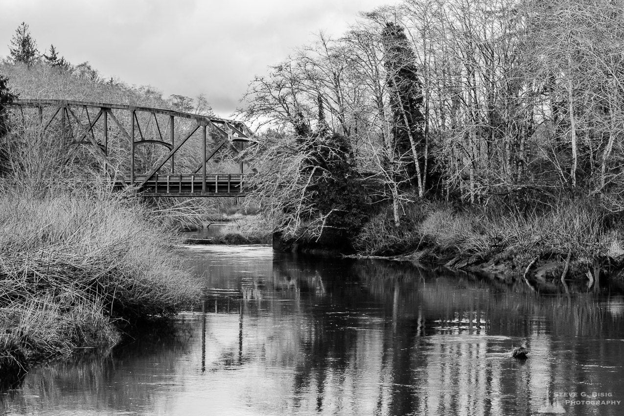A black and white landscape photograph of the SR109 bridge over the Humptulips River in rural Grays Harbor County, Washington.