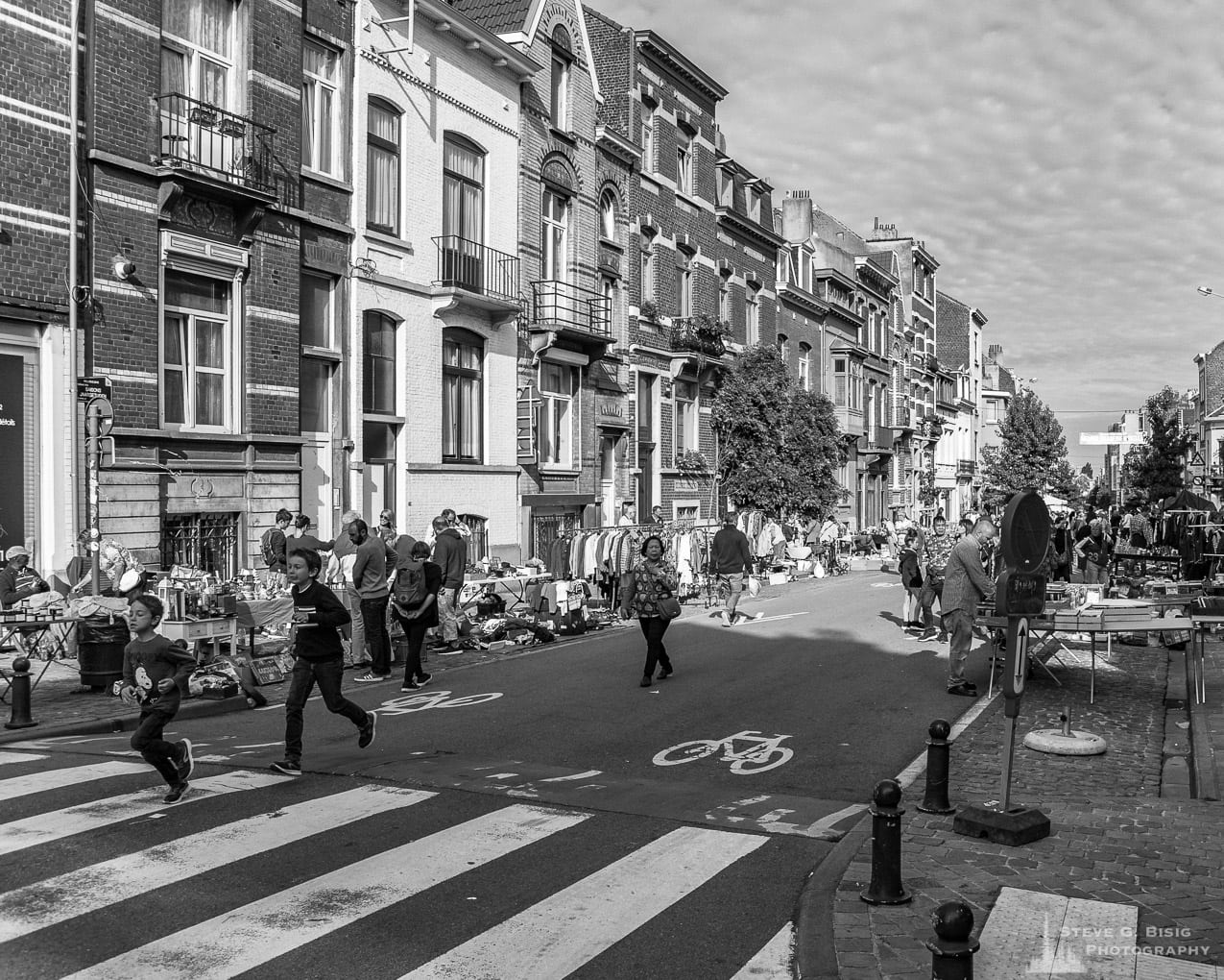 One of a series of black and white photographs from the 2018 Grande Braderie D'Ixelles sidewalk sale and street festival in Brussels, Belgium.