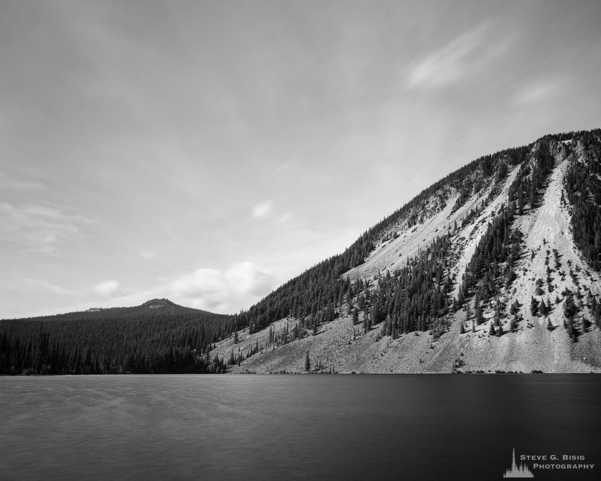 A long exposure black and white landscape photograph of Spiral Butte at Dog Lake near White Pass, Washington.