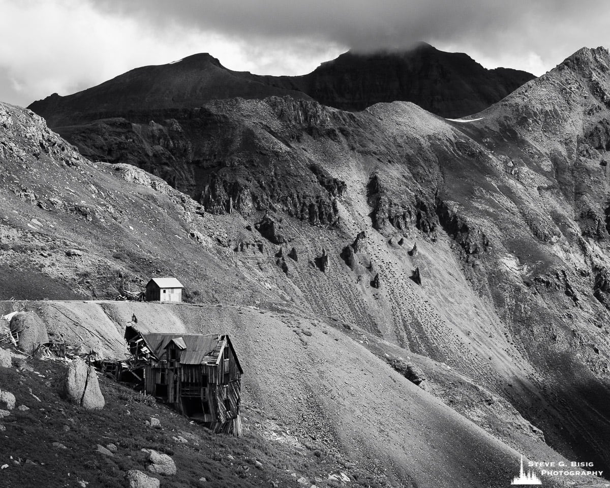 A black and white fine art landscape photograph of the ruins of the Mountain Top Mine in Governor Basin, Colorado.