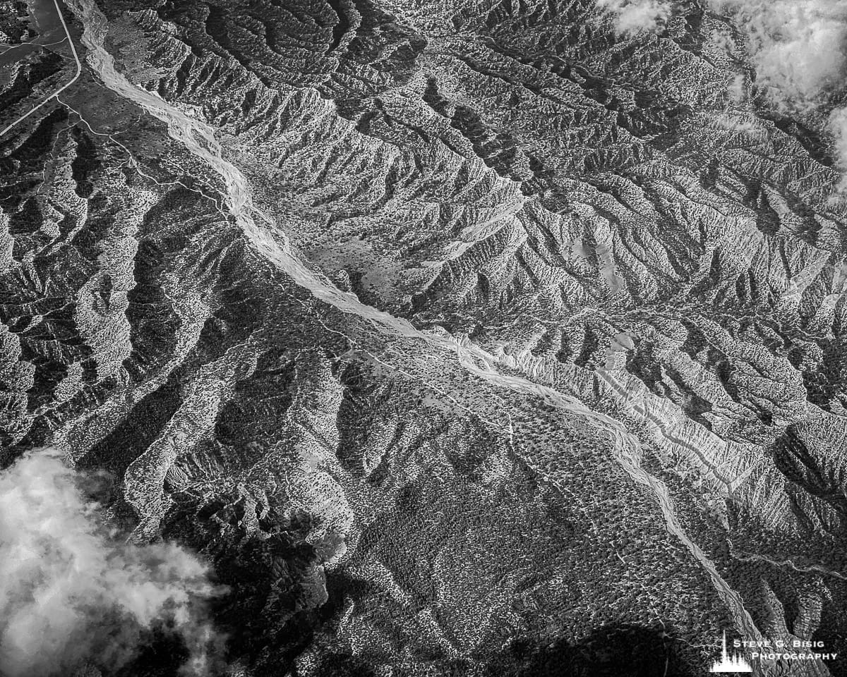A black and white mobile aerial photograph taken over California desert. 