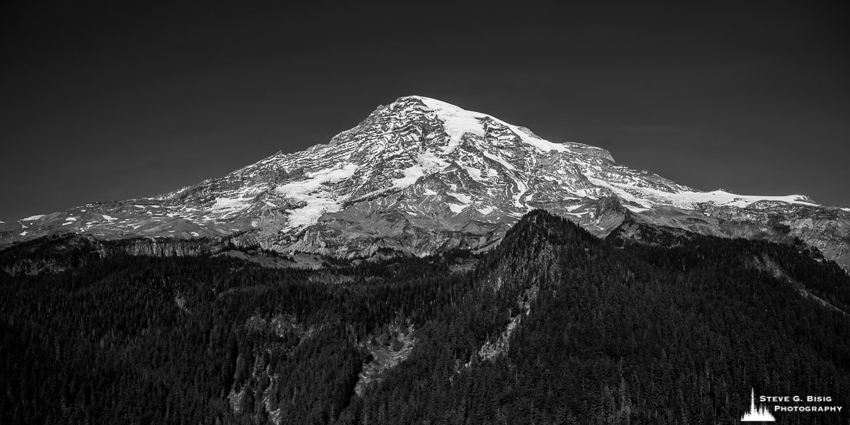 A black and white panoramic landscape photography of Mt. Rainier as viewed from Ricksecker Point on an early autumn day in Mount Rainier National Park, Washington.