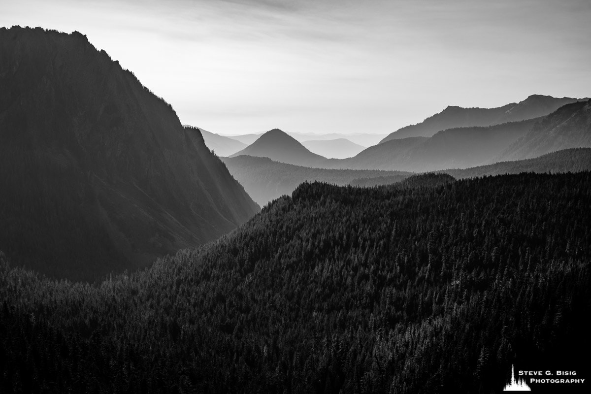 A black and white landscape photograph of multiple ridges of mountains looking down the Nisqually River drainage at Mt. Rainier National Park, Washington.
