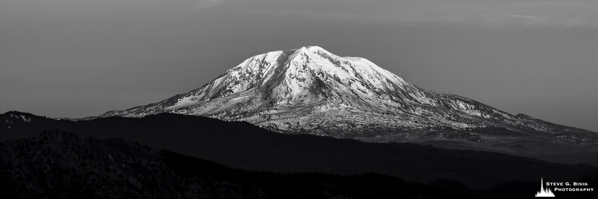 A black and white panoramic landscape photograph of Mt. Adams as viewed from Windy Ridge in Skamania County, Washington.