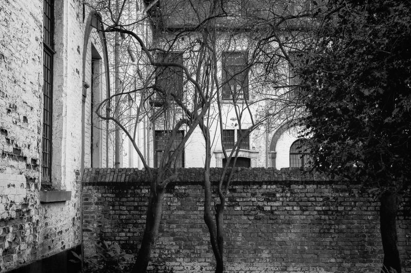A black and white photograph of the courtyard of the abbey school building at Abbaye de La Cambre in Brussels, Belgium.
