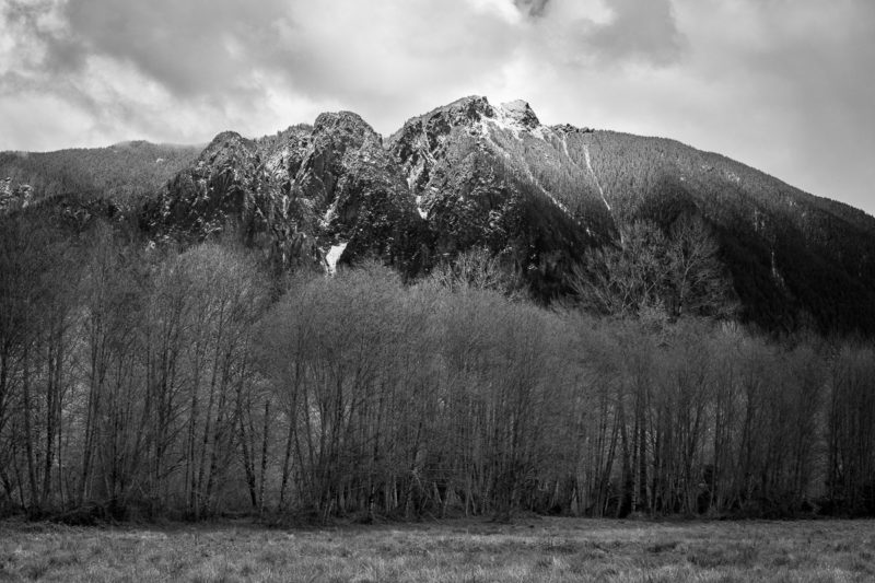 A black and white landscape photograph of Mt. Si near North Bend, Washington after a spring snowfall.