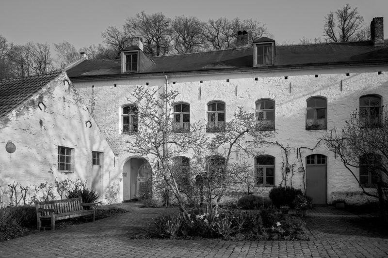 A black and white photograph of Le Porterie (The Gatehouse) at Rouge Cloître, Auderghem, Belgium.