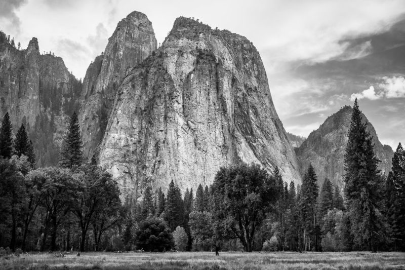 A black and white landscape photograph of Cathedral Rocks on an autumn morning in Yosemite National Park, California.