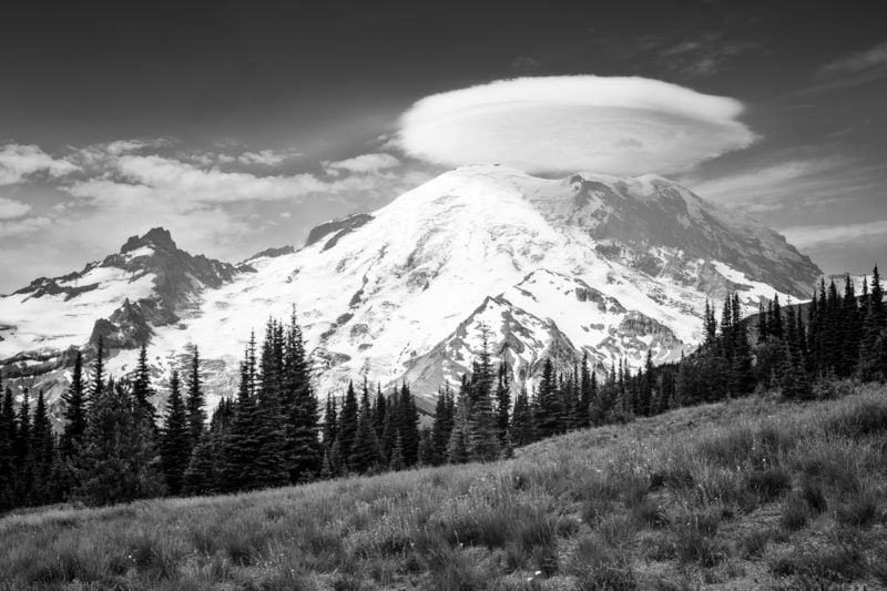 A black and white landscape photograph of a Lenticular cloud over Mt. Rainier, Washington.
