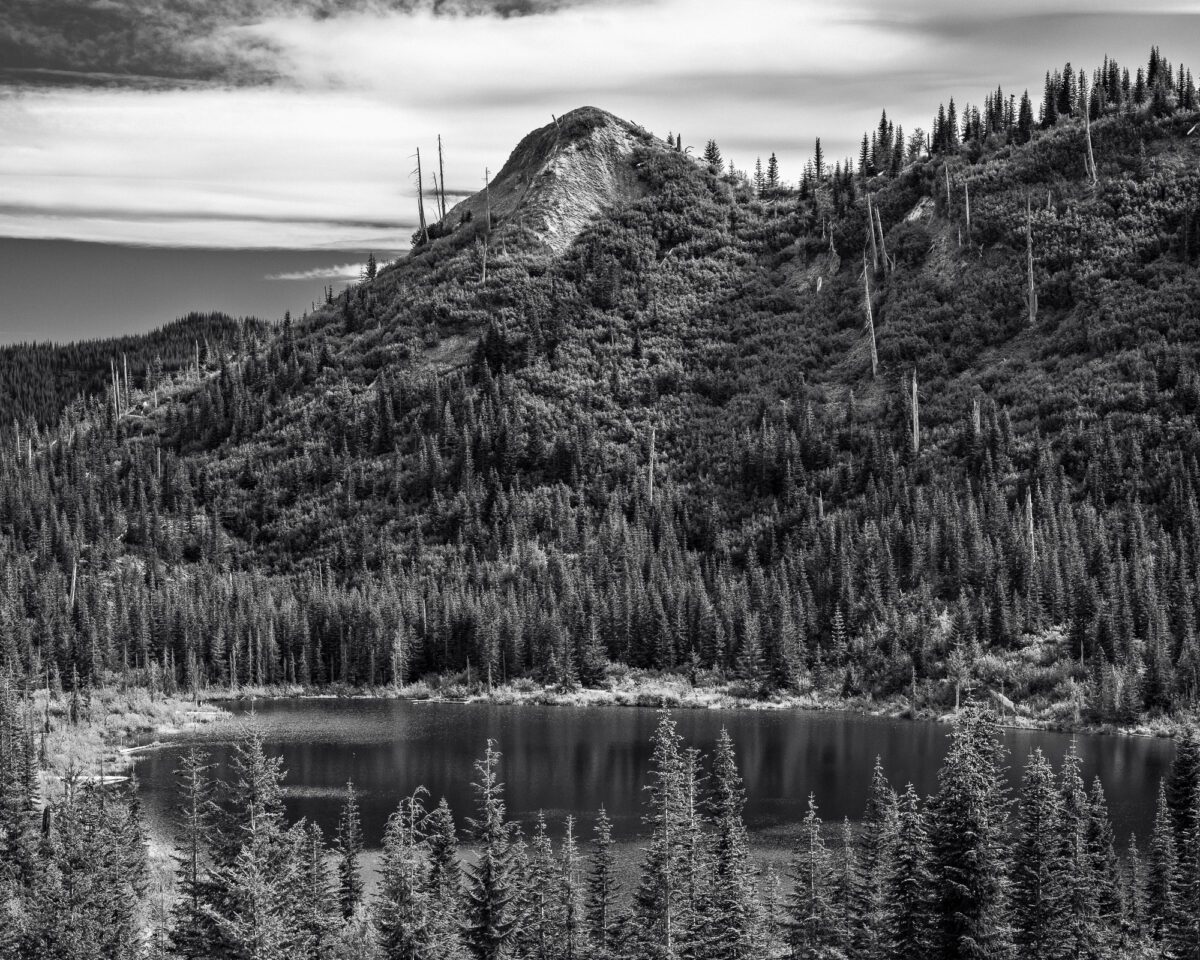 A black and white landscape photograph of Meta Lake in the Gifford Pinchot National Forest near Mt. St. Helens in Skamania County, Washington.
