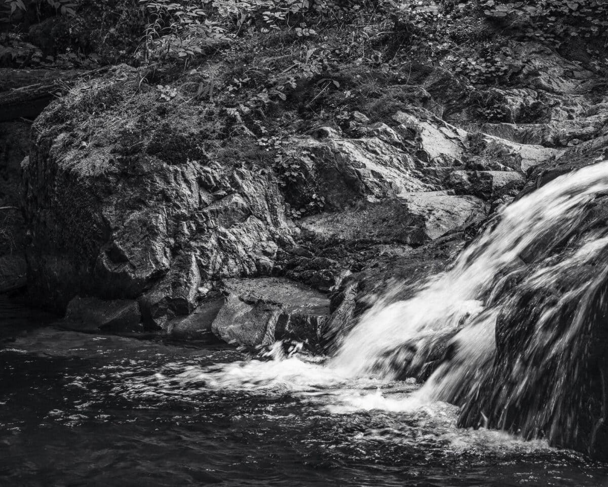 A black and white intimate landscape of a waterfall along Quartz Creek in the Gifford Pinchot National Forest in Skamania County, Washington.
