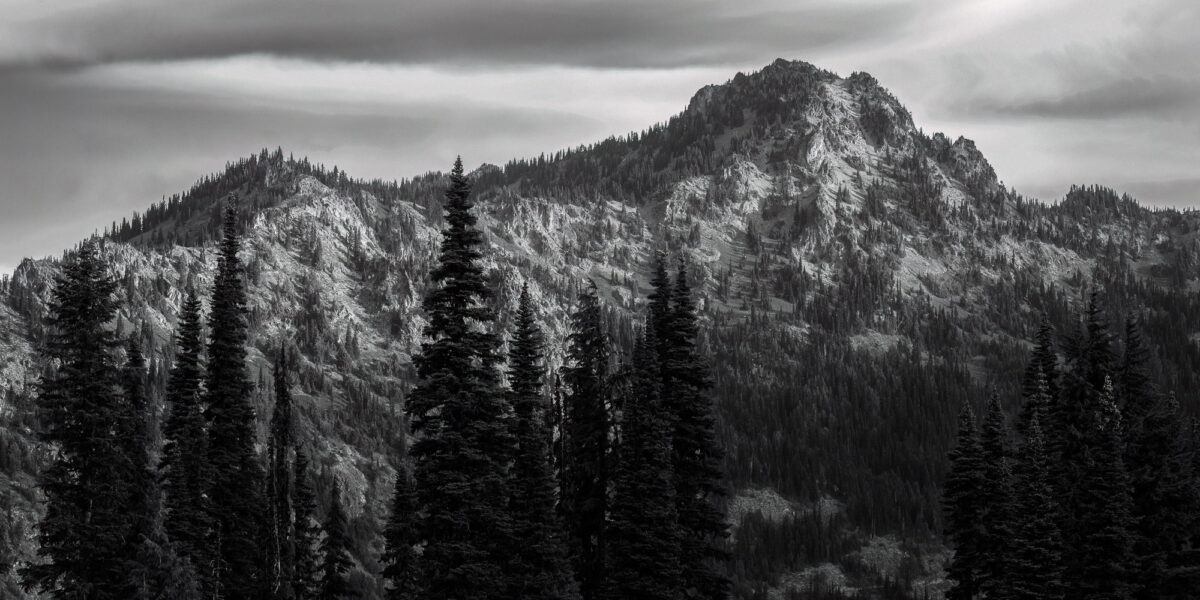 A black and white panoramic landscape photograph of 6,904 foot Chinook Peak as viewed along the Naches Peak Loop trail near Chinook Pass, Washington.