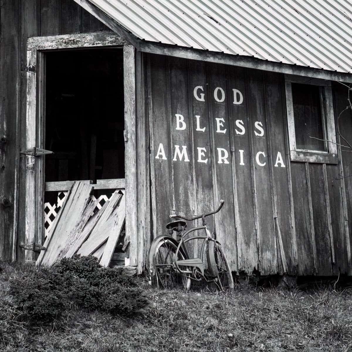 A close-up black and white photograph of an old barn and bicycle in rural Grays Harbor County, Washington.