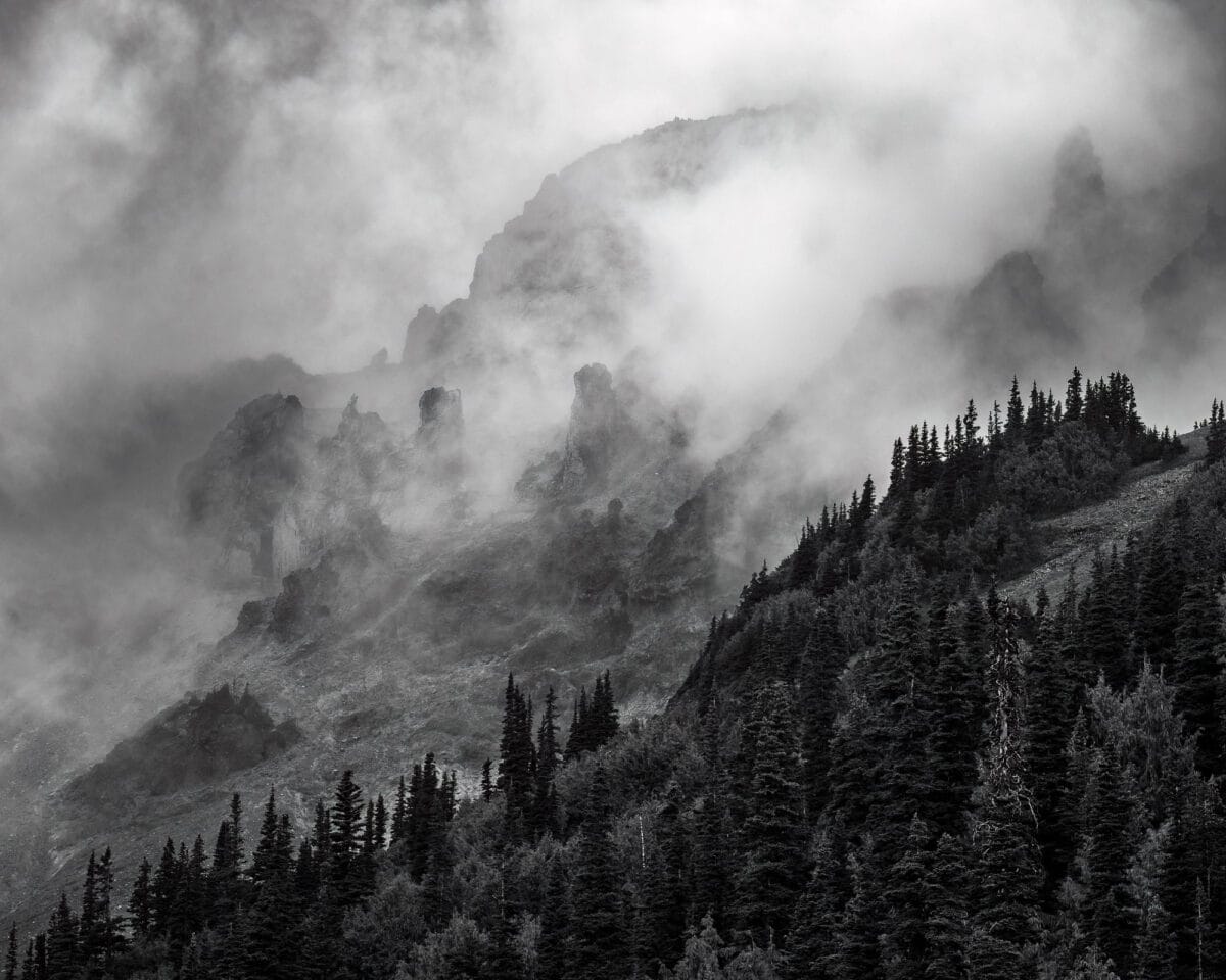 Amidst the mist and mountains, there is a serene beauty that can only be found in nature. This black and white landscape photograph captures the ethereal quality of the peaks below 3rd Burroughs Mountain in Mt. Rainier National Park, Washington.