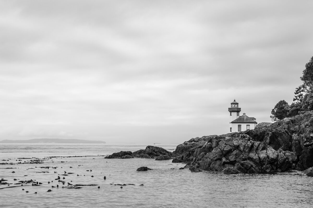 A black and white photograph of the Lime Kiln Lighhouse on the western shore of San Juan Island, Washington.