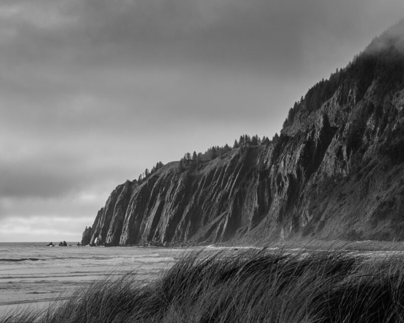 A black and white lanadscape photograph of Neahkahnie as viewed from Manzanita, Oregon.