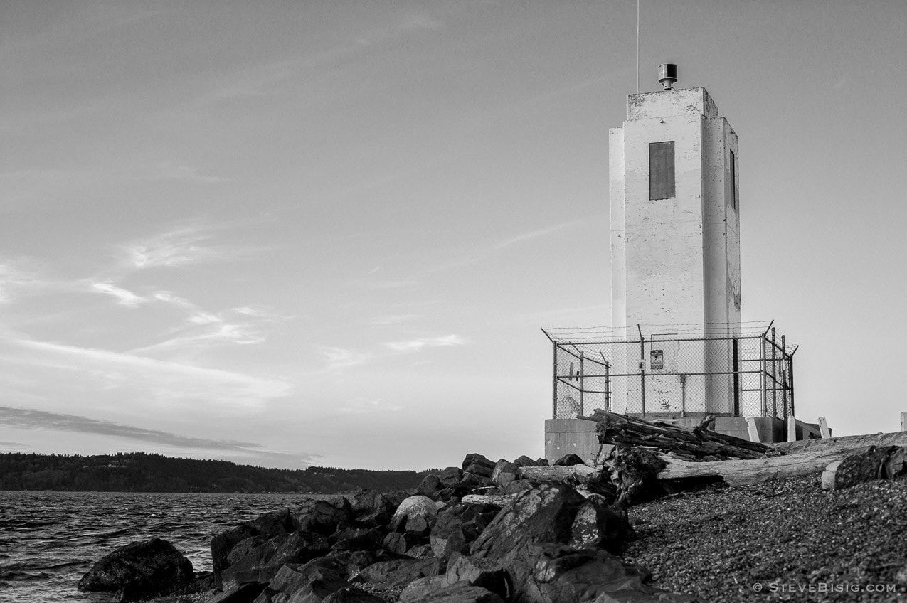 A black and white photograph of the Puget Sound and lighthouse at Browns Point, Washington.