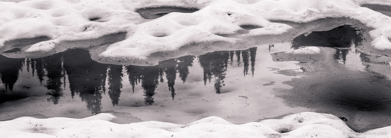A black and white panoramic photograph of the melting snow in Mt Rainier National Park near Chinook Pass, Washington.