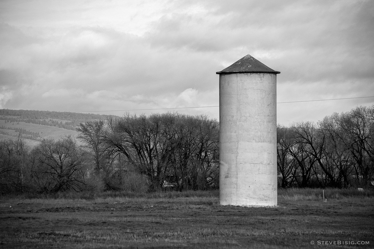 A black and white photograph of an old grain silo in Ellensburg, Washington threatened by commercial development.