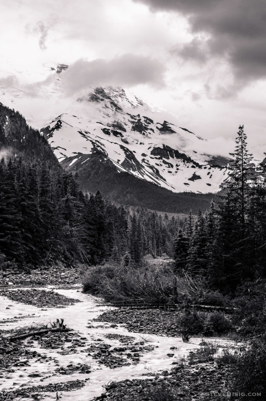 A black and white photograph of Mount Rainier and the White River on a cloudy Summer day in the Mount Rainier National Park, Washington.