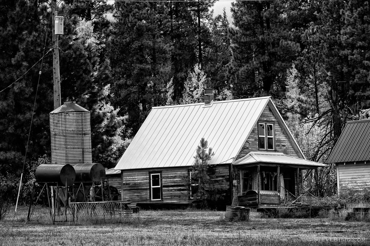 A black and white photograph of an old farmhouse off of Upper Peoh Point Road in rural Kittitas County near Cle Elum, Washington.