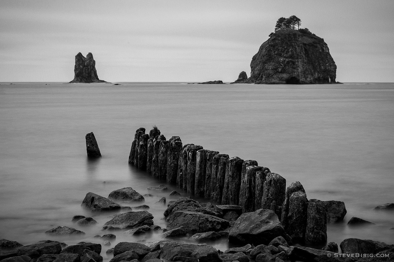 A long exposure black and white photograph of the pilings and seastacks along the Pacific Ocean at La Push , Washington.