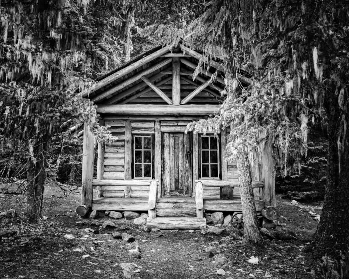 A black and white photograph of the White River Patrol Cabin at Mt Rainier National Park, Washington.